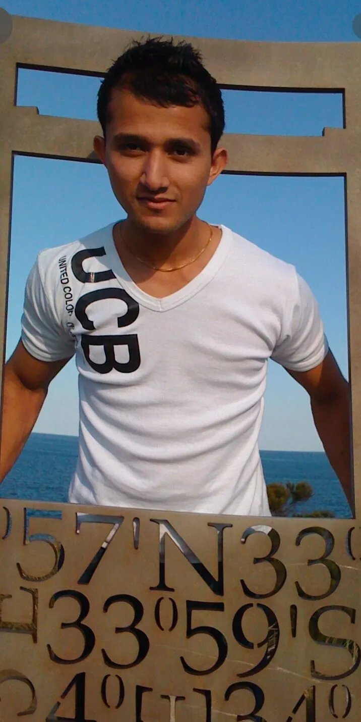Sol, slim, in a white t-shirt, soon after arriving in Australia