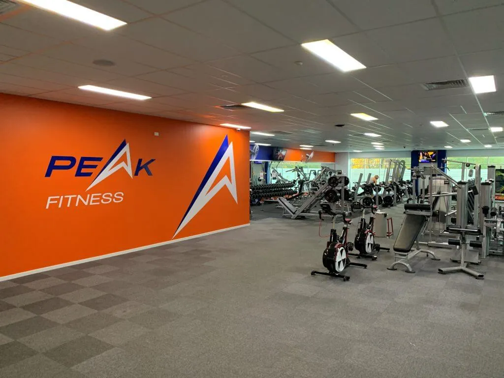 Inside Peak Fitness Thornlands, with the orange Peak feature wall